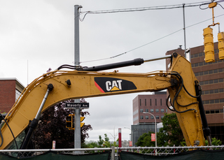 An excavator sits at the edge of the sewer line replacement project along Waverly Avenue near the intersection with University Avenue. The project is expected to be completed in August. Photo taken July 25, 2017